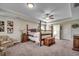 Spacious main bedroom with a four-poster bed, neutral tones, and an ensuite bathroom at 8605 Hopper Ct., Myrtle Beach, SC 29579