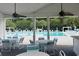 Outdoor poolside dining area with tables and chairs under a shaded structure at 8605 Hopper Ct., Myrtle Beach, SC 29579