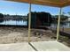 A concrete back porch offers gorgeous views of a pond lined with mature trees in a serene backyard at 1020 Clamour Ct., Conway, SC 29526