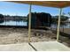 A covered back porch area overlooking a serene waterfront view, perfect for relaxation at 1020 Clamour Ct., Conway, SC 29526