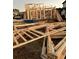 Image showcasing the wooden frame construction of a new two-story home with building materials on site at 1020 Clamour Ct., Conway, SC 29526