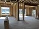 Unfinished interior with large windows providing ample natural light and views of a pond at 1020 Clamour Ct., Conway, SC 29526