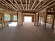 A spacious, unfinished interior shows the framing, window openings, and layout of a new home at 1020 Clamour Ct., Conway, SC 29526