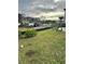 Image shows the grassy yard being prepared for construction with heavy machinery, landscape, and some trees at 1020 Clamour Ct., Conway, SC 29526