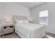 Cozy bedroom with a queen-size bed, side table, and natural light at 134 Hancher Dr., Myrtle Beach, SC 29588