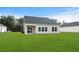 Spacious backyard with grassy lawn and tan house exterior at 2040 Copper Creek Loop, Longs, SC 29568