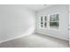 Bright bedroom featuring carpet and two windows at 2040 Copper Creek Loop, Longs, SC 29568