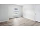 Simple bedroom with wood-look floors and a window at 2040 Copper Creek Loop, Longs, SC 29568