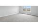 Simple bedroom with neutral carpeting and window overlooking pond at 2040 Copper Creek Loop, Longs, SC 29568