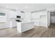 Modern kitchen with white cabinets, center island, and stainless steel appliances at 2040 Copper Creek Loop, Longs, SC 29568
