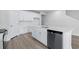 Kitchen island with white cabinets, quartz countertops and stainless steel dishwasher at 2040 Copper Creek Loop, Longs, SC 29568