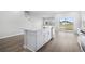 Kitchen island with white cabinets and quartz countertop, overlooking backyard at 2040 Copper Creek Loop, Longs, SC 29568