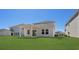 Spacious backyard featuring lush green grass and a covered patio for outdoor entertaining at 2048 Copper Creek Loop, Longs, SC 29568