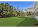 Expansive backyard lawn bordered by mature trees, offering privacy and a tranquil outdoor space at 2048 Copper Creek Loop, Longs, SC 29568