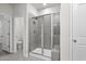 Tiled shower with glass enclosure and a door to the toilet and sink area at 2048 Copper Creek Loop, Longs, SC 29568