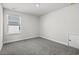 Cozy bedroom featuring neutral walls, plush carpeting, and a bright window at 2048 Copper Creek Loop, Longs, SC 29568