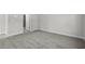 An empty bedroom with neutral carpet and a doorway leading to an ensuite bathroom with glass shower doors at 2048 Copper Creek Loop, Longs, SC 29568