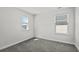 Well-lit bedroom featuring neutral walls, plush carpeting, and bright windows at 2048 Copper Creek Loop, Longs, SC 29568