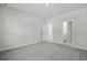 Bright bedroom featuring neutral walls, plush gray carpeting, and doorways to the bathroom and closet at 2048 Copper Creek Loop, Longs, SC 29568