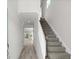 Bright entryway showcasing a staircase with carpeted steps and wood handrail, leading to an open living space at 2048 Copper Creek Loop, Longs, SC 29568