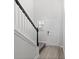 Welcoming entryway featuring modern wood flooring, a staircase with carpet, and a view of the front door at 2048 Copper Creek Loop, Longs, SC 29568