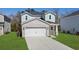 Attractive home featuring a white brick facade, attached garage, and a well-maintained front lawn at 2048 Copper Creek Loop, Longs, SC 29568