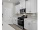 Stylish kitchen boasting stainless steel appliances, light countertops, and modern white cabinetry at 2048 Copper Creek Loop, Longs, SC 29568