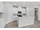 Bright kitchen featuring white cabinets, stainless steel appliances, tile backsplash, and a kitchen island at 2048 Copper Creek Loop, Longs, SC 29568