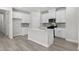 Modern kitchen featuring white cabinets, stainless steel appliances and a large island with a sink at 2048 Copper Creek Loop, Longs, SC 29568