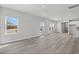 Open concept living area with luxury vinyl plank flooring and abundant natural light from large windows at 2048 Copper Creek Loop, Longs, SC 29568