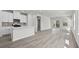 Open concept living area with hardwood floors, kitchen island and sliding doors to exterior at 2048 Copper Creek Loop, Longs, SC 29568