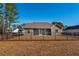 Home features a fenced backyard with mature trees and landscaping at 363 Long Meadow Dr., Loris, SC 29569