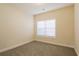 Bright bedroom with neutral walls and carpet, featuring a window with blinds at 363 Long Meadow Dr., Loris, SC 29569
