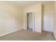 Empty bedroom with neutral walls and carpet, featuring a closet and door at 363 Long Meadow Dr., Loris, SC 29569