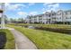 Building exterior showcasing a tranquil pond and walking path at 3762 Citation Way # 1018, Myrtle Beach, SC 29577