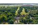 Aerial view of a community golf course surrounded by lush trees and winding waterways at 92 Patriot Ct., Georgetown, SC 29440