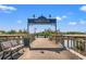 Scenic view of the Harborwalk featuring a wooden boardwalk, benches, and waterfront views at 92 Patriot Ct., Georgetown, SC 29440