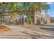 Charming brick building with a mural, American flags, mature trees, and outdoor benches at 92 Patriot Ct., Georgetown, SC 29440