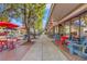 Charming street with outdoor dining, colorful chairs, lush trees, and storefronts at 92 Patriot Ct., Georgetown, SC 29440