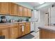Efficient kitchen with wood cabinets, appliances, and stackable washer/dryer at 400 20Th Ave. N # 303, Myrtle Beach, SC 29577
