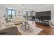 Living room with hardwood floors, sofas, and large TV at 400 20Th Ave. N # 303, Myrtle Beach, SC 29577