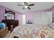 Bedroom with floral bedding, ceiling fan, dresser, and access to hallway at 5001 Little River Rd. # E-219, Myrtle Beach, SC 29577