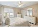 Sun-filled bedroom features a ceiling fan, window, and matching white dresser at 6706 Bryant St. # B, Myrtle Beach, SC 29572
