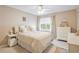 Well-lit bedroom with a ceiling fan, window and matching nightstand and dresser at 6706 Bryant St. # B, Myrtle Beach, SC 29572