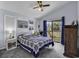 Comfortable bedroom with a ceiling fan, artwork, and a private balcony offering outdoor views at 859 Tall Oaks Ct. # A, Myrtle Beach, SC 29588
