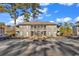Condominium building with multiple units, parking lot, mature trees, and staircase entries at 859 Tall Oaks Ct. # A, Myrtle Beach, SC 29588