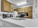 Functional kitchen with white countertops, wood cabinets, and modern appliances at 859 Tall Oaks Ct. # A, Myrtle Beach, SC 29588