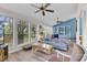 Bright living room boasts large windows, a cozy couch, and built-in shelves for decor and storage at 859 Tall Oaks Ct. # A, Myrtle Beach, SC 29588