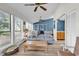 Inviting living room featuring a comfortable couch, natural light from many windows, and stylish ceiling fans at 859 Tall Oaks Ct. # A, Myrtle Beach, SC 29588