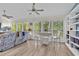 Inviting living room with hardwood floors, lots of windows and natural light, and a ceiling fan at 859 Tall Oaks Ct. # A, Myrtle Beach, SC 29588